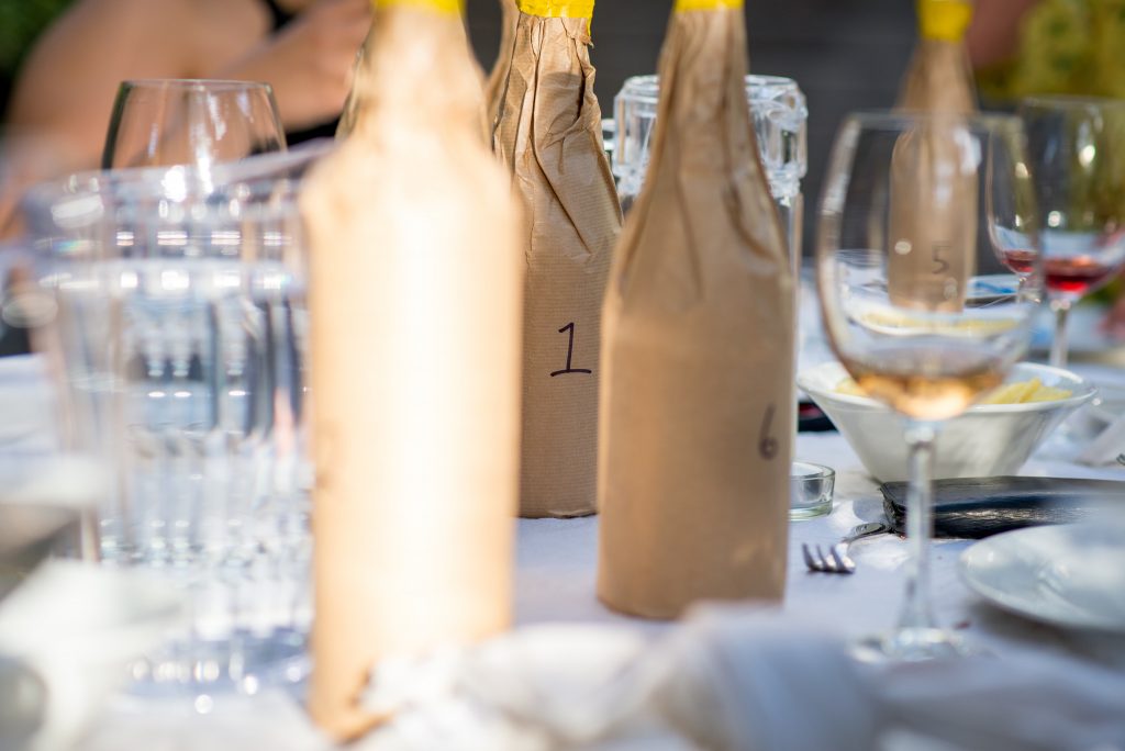 blind taste test wine bottles covered up