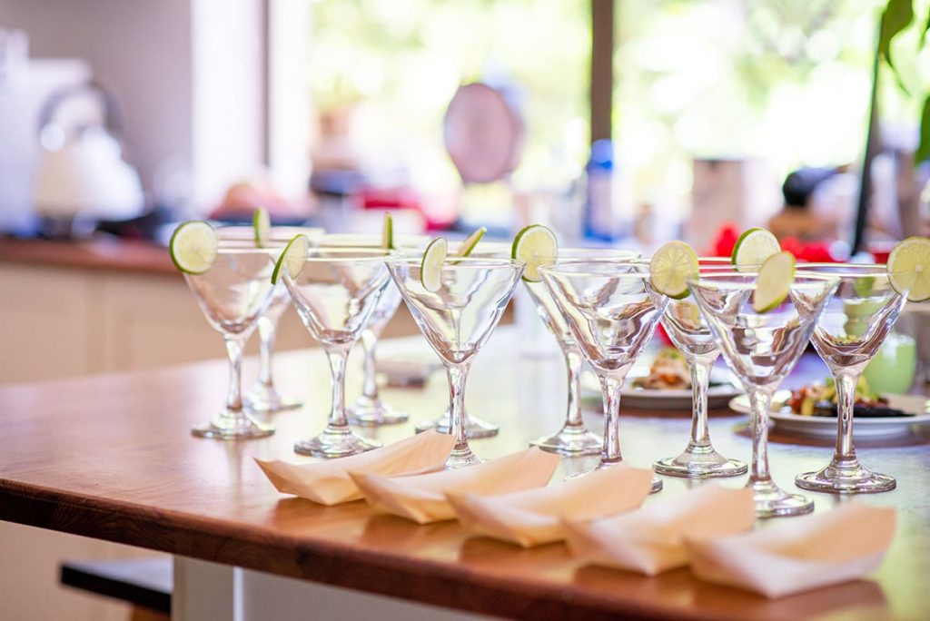 Lineup of cocktail glasses and bamboo boats