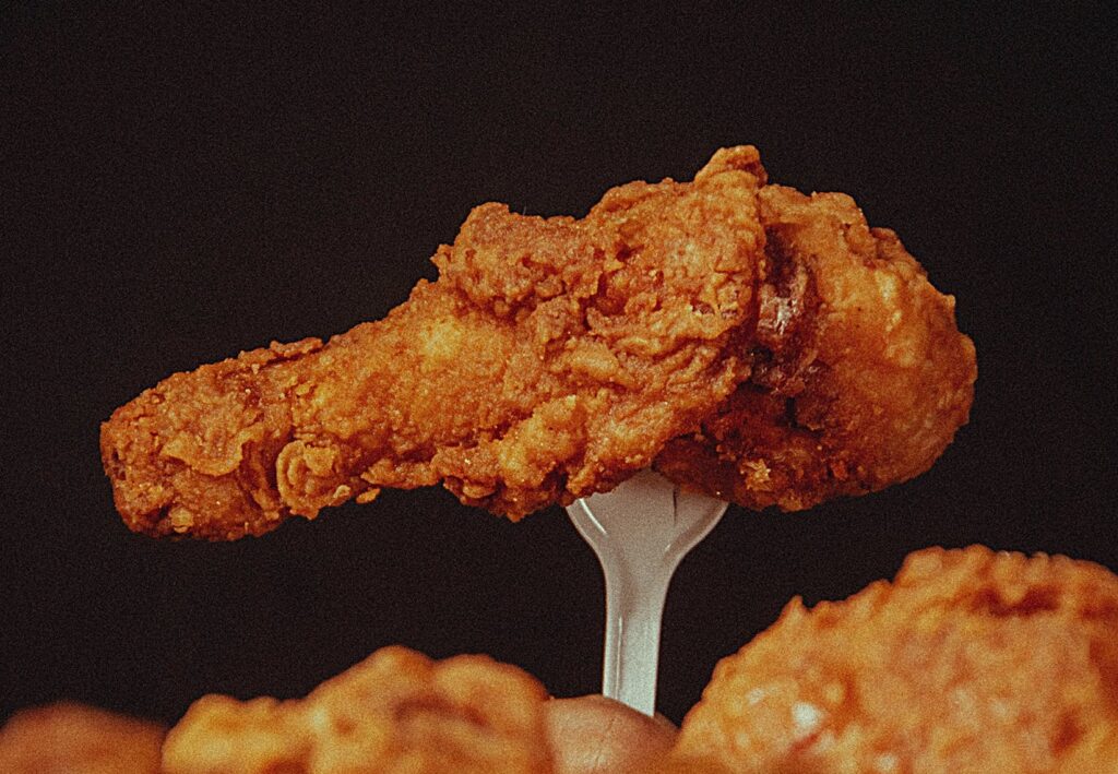 Hot ones cover image of a fork piercing a hot wing